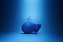 Creative Composition Of Toy Dolphin Placed On Blue Surface For Ocean Concept In Studio