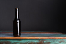 Dark Glass Bottle Of Alcoholic Drink On Painted Square Shaped Wooden Table At Home