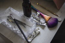 From Above Of Various Brushes With File Placed On Table With Foils And Nail Clippers In Beauty Salon