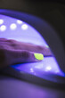 © Francesc Juan/ADDICTIVE STOCK - Crop anonymous female putting hands into UV nail lamp dryer for gel polish after manicure