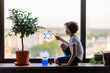 Little Jewish boy draws the Star of David sign on the window. The symbol of Israel. Solidarity support sympathy. Judaism sign. Religious holiday. Independence Day. The child waiting father from war