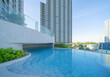 © tampatra - Swimming pool on rooftop of hotel apartment building in Bangkok downtown skyline, urban city view. Relaxing in summer season in travel holiday vacation concept. Recreation lifestyle.
