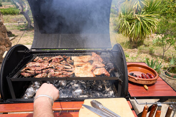 Wall Mural - cooking on a charcoal and wood barbecue