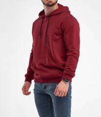 Wall Mural - Bearded guy wears dark red hoodie. Man standing in studio in fleece jacket with hood