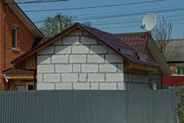 Poster - white brick private house behind a gray metal fence on a rural street