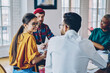 © BullRun - Group of cheerful diverse students analyzing information during productive cooperation meeting for communicate, happy multiracial hipster guys 20s planning together working process enjoying friendship