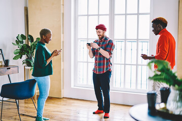 Poster - diverse male and female best friends playing online games connected to bluetooth on modern smartphon