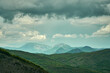 The lush green Kraishte mountain ranges in Bulgaria, Europe, in spring, against a dramatic cloud backdrop, as seen from the Lubash peak slopes.