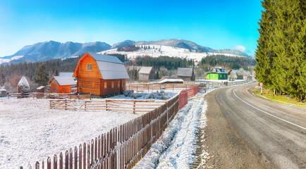 Wall Mural - Fantastic winter landscape with wooden houses in snowy mountains.