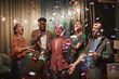 © Seventyfour - Diverse group of young people dancing under confetti shower while enjoying party with friends indoors