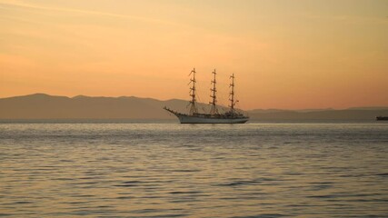 Canvas Print - Seascape with a sailboat on the background of the sunset.