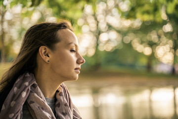 Portrait of a beautiful young woman outdoors in the city. Urban landscape. Travel and freelance lifestyle. Youth and beauty