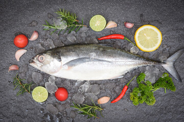 Wall Mural - Fish on ice for cooking food in the restaurant, Fresh fish raw torpedo scad with lemon herb and spices, mackerel scad top view