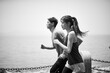 © imtmphoto - young asian man and woman running outdoors on beach, black and white