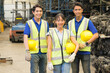 © Chaiya - Woman and men work together, they hold helmets and look right side in medium shot. Asian engineer worker woman and man show teamwork by holding helmets and looking right side in factory-warehouse