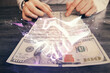 © peshkova - Multi exposure of handshake drawing hologram and USA dollars bills and man hands.