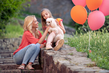 Canvas Print - Mom with her daughter relaxing outdoors