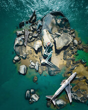 Aerial view of a commercial plane crashed on the ground along the river on the rocks, Xiamen, China.