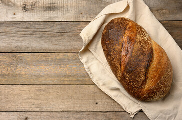 baked round bread made from white wheat board on wooden table