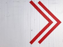 Red Arrow Symbol On White Wall