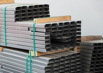 Canvas Print - heap of C shape stainless steel bar. raw meterial for steel structure. pile of chanel metal bar.