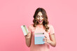 © GVS - Excited smiling woman woman opening gift box over pink background