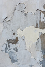 Old Grey Painted Concrete Wall Background With Peeling Stucco.  Grunge Wall Texture With Flaking Plaster. Empty Abstract Distressed  Paint And Plasterwork Backdrop. Aged Cement Masonry With Copy Space