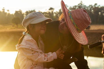 Mother and daughter in the countryside at sunset