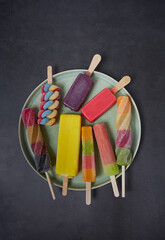 Sticker - colorful ice cream popsicles on dark backrgound