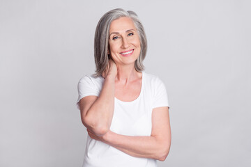 Wall Mural - Photo of charming shiny age woman dressed white outfit smiling arm neck isolated grey color background