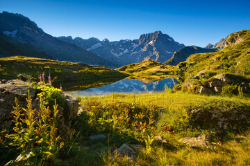 lauzon lake in the ecrins national park in summer with a view on the sirac mountain peak. the lake i