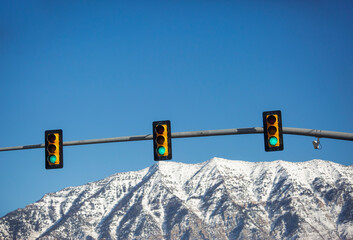 Closeup shot of traffic lights with mountains in the background