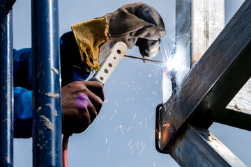 The welding of a metal welder that makes the metal spark.