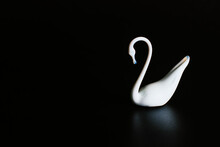 Porcelain Figurine Of A White Swan On A Black Background