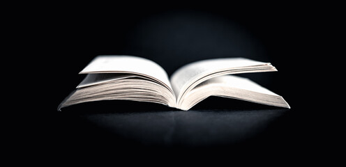 Old vintage open book on black background