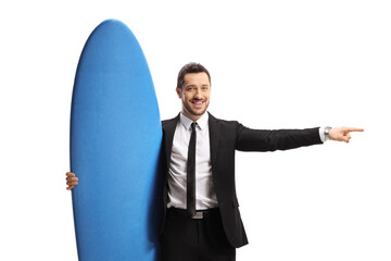 Wall Mural - Businessman holding a surfing board and pointing to the side