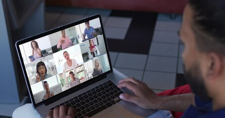 Poster - African american man having a video conference with office colleagues on laptop at home