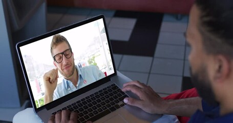 Sticker - African american man having a video call with male office colleague on laptop at home