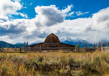 Historic Moulton Barns N Mormons' Row Against The Dramatic Teton Mountain Range  In Wyoming.