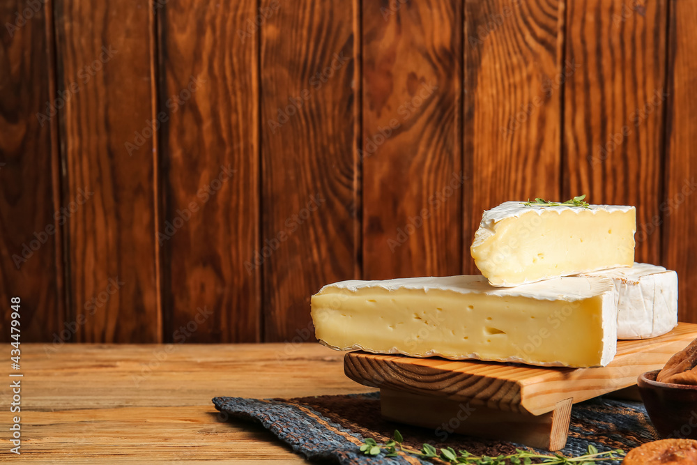 Tasty cheese on wooden background