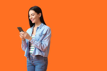 Young woman with mobile phone on color background