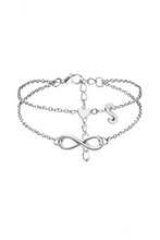 Detail Shot Of Silver Anklet Made As Double-row Chain With Charms Shaped As Infinity Sign, Heart And Letter S. The Elegant Foot Bracelet With Lobster Clasp Is Isolated On The White Background. 