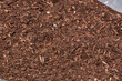 Mulching the garden with brown bark wood chip as water and weed protection