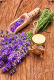 Fototapeta  - Lavender essential oil, bunch of lavender flowers on wooden board