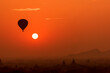 © Travel 'n' Lifestyle - Hot air balloon close to the sun over temples of Bagan, Myanmar at sunrise.