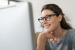 © StockPhotoPro - Woman with glasses working on a computer