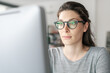 © StockPhotoPro - Woman with glasses working on a computer