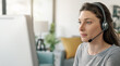 © StockPhotoPro - Woman wearing a headset and working with her computer