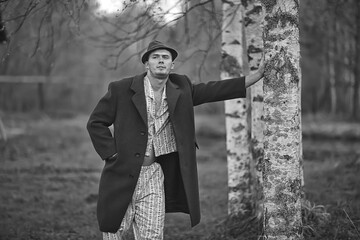 vintage man young village black and white, eastern europe style, retro coat and boots