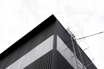 Wall Mural - Black and white corrugated iron sheet used as a facade of a warehouse or factory. Texture of a seamless corrugated zinc sheet metal aluminum facade. Architecture. Metal texture.